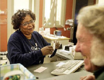 
Carol Staggers prepares a withdrawal for David Willett at the Compass Bank in Pioneer Square in Seattle. The Compass Center Bank is the nation's only bank aimed at homeless people. 
 (Mike Siegel/Seattle Times / The Spokesman-Review)