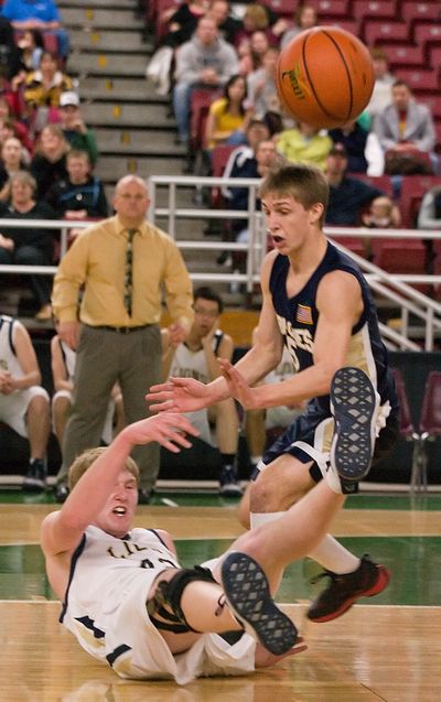 Moses Lake Christian’s Riggs Yarbro hits the floor after passing the ball.  (Associated Press / The Spokesman-Review)