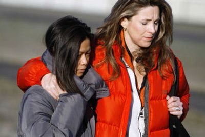 
Karen James, left, wife of Kelly James, and Michaela Cooke, wife of Jerry Cooke, support each other following a news conference Sunday in Hood River, Ore. 
 (Associated Press / The Spokesman-Review)