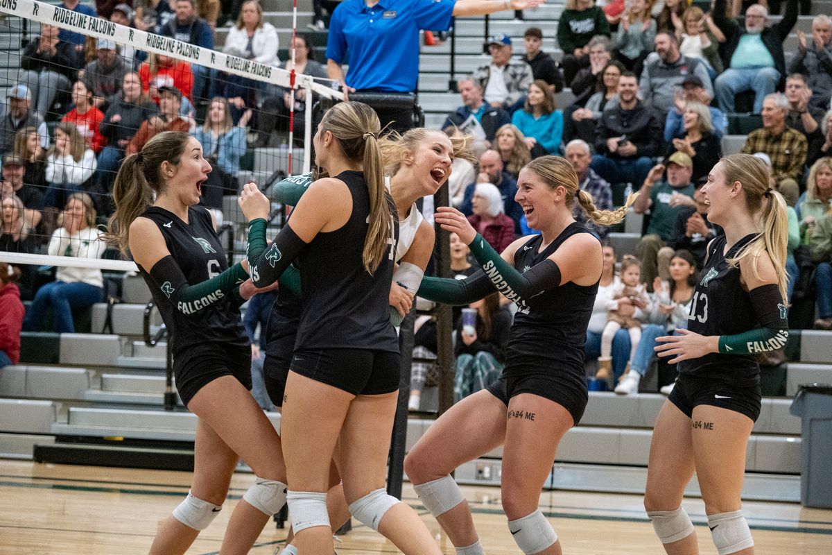 Ridgeline volleyball players celebrate winning a point during the first set against Mt. Spokane in the District 6 3A championship match on Thursday at Ridgeline High School in Liberty Lake. Both teams will play in next week’s state tournament.  (Madison McCord/For The Spokesman-Review)