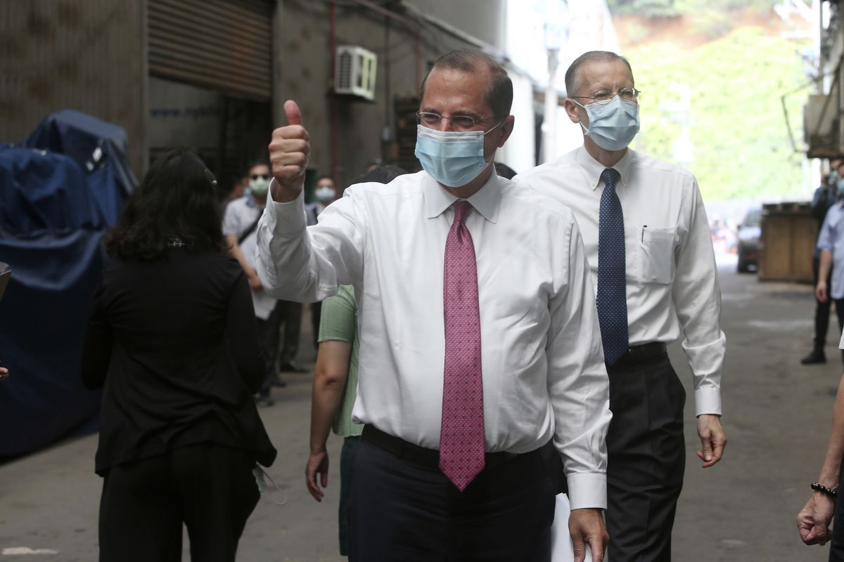 U.S. Health and Human Services Secretary Alex Azar thumbs up as he visits a mask factory with Director of the American Institute in Taiwan (AIT) William Brent Christensen, right, in New Taipei City, Taiwan Wednesday, Aug. 12, 2020. Wednesday is the last day of Azar