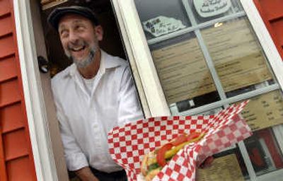 
Tom Hayes, owner of Chicago Joe's in Coeur d'Alene serves up a Chicago style hot dog. 
 (Kathy Plonka / The Spokesman-Review)