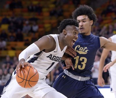 Montana State guard Isaac Bonton (13) defends Utah State’s Koby McEwen (1) during an NCAA basketball game, Monday, Nov. 13, 2017, in Logan, Utah. (Eli Lucero / AP)