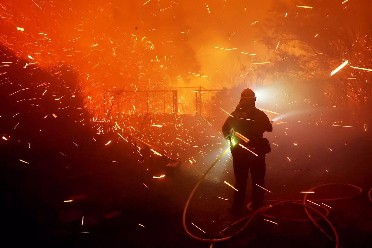 Firefighters battle the Franklin fire next to a business along Pacific Coast Highway in Malibu.  (Wally Skalij/Los Angeles Times/TNS)