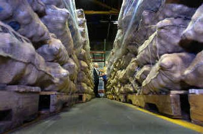
About 40,000 pounds of fresh potatoes frame Roger Morse of the Rotary Club, left, and Jason Clark, of Second Harvest Inland Northwest, on Tuesday morning. 
 (Christopher Anderson/ / The Spokesman-Review)