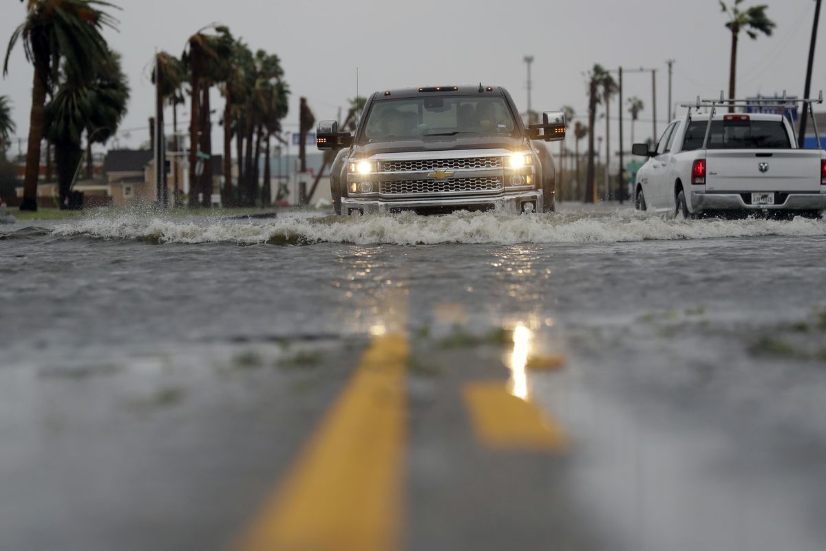 A drives moves through flood waters left behind by Hurricane Harvey, Saturday, Aug. 26, 2017, in Aransas Pass, Texas. Harvey rolled over the Texas Gulf Coast on Saturday, smashing homes and businesses and lashing the shore with wind and rain so intense that drivers were forced off the road because they could not see in front of them. (Eric Gay / Associated Press)