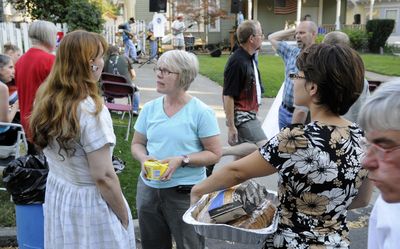 Patricia Hansen, left, talks with Janice Verdugo, center, and Cody Marquart during a National Night Out against crime gathering Tuesday.  (Dan Pelle / The Spokesman-Review)