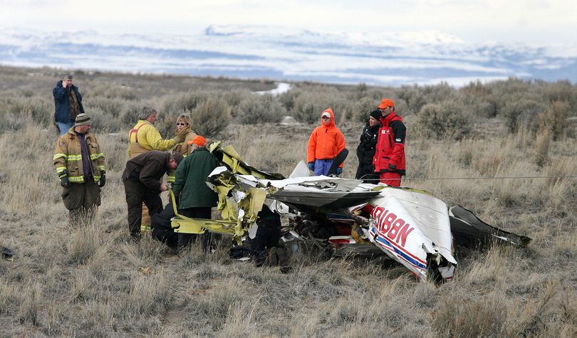 ORG XMIT: IDTWF102 Elmore County emergency personnel walk away from a plane crash site west of Hagerman, Idaho on Tuesday Feb. 17, 2009. The wreckage of a light plane that crashed on a flight to Utah was found Tuesday in southwestern Idaho. Authorities believe the pilot, Craig Jewett, a Utah resident, who was alone in the plane, died in the crash. (AP Photo/Times-News, Ashley Smith) (Ashley Smith / The Spokesman-Review)