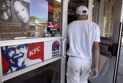 A customer walks into a KFC restaurant in San Francisco on Oct. 7.  New chicken wraps priced under $1.50 are proliferating at places like Burger King and KFC.  (Associated Press / The Spokesman-Review)