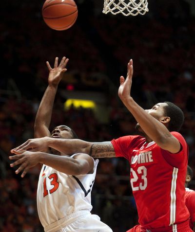 Illinois guard Tracy Abrams (13), who scored 13 points for the Fighting Illini, shoots past Ohio State center Amir Williams (23). (Associated Press)