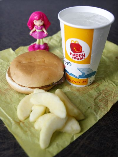 McDonald’s is adding fruits or vegetables to Happy Meals to be introduced in September. (Associated Press)