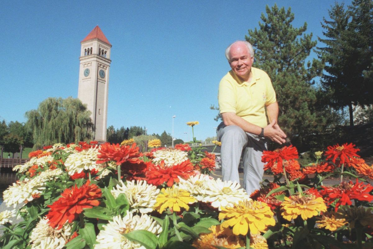 Riverfront Park Manager Hal McGlathery stops to enjoy the flowers on a bright fall day in 1996. (Christopher Anderson/The Spokesman-Review)
