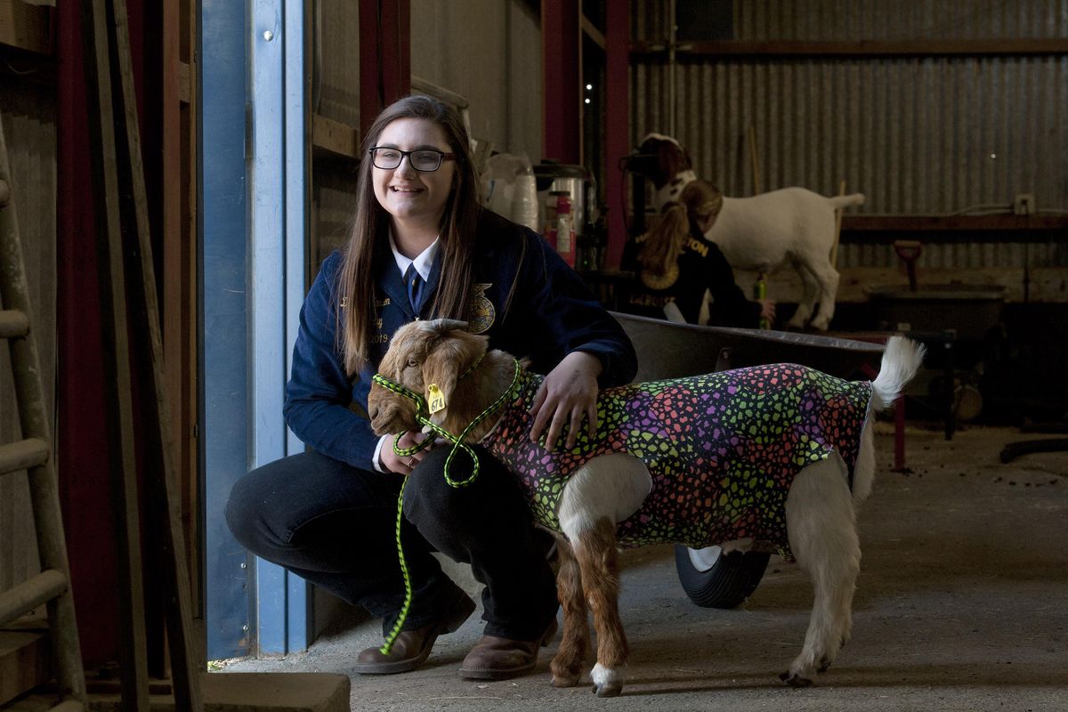 East Valley senior Dakota Hanson poses for a photograph with Timmy her goat before competition during the Junior Livestock Show at Spokane County Fair & Expo Center on Thursday, May 2, 2019. (Kathy Plonka / The Spokesman-Review)