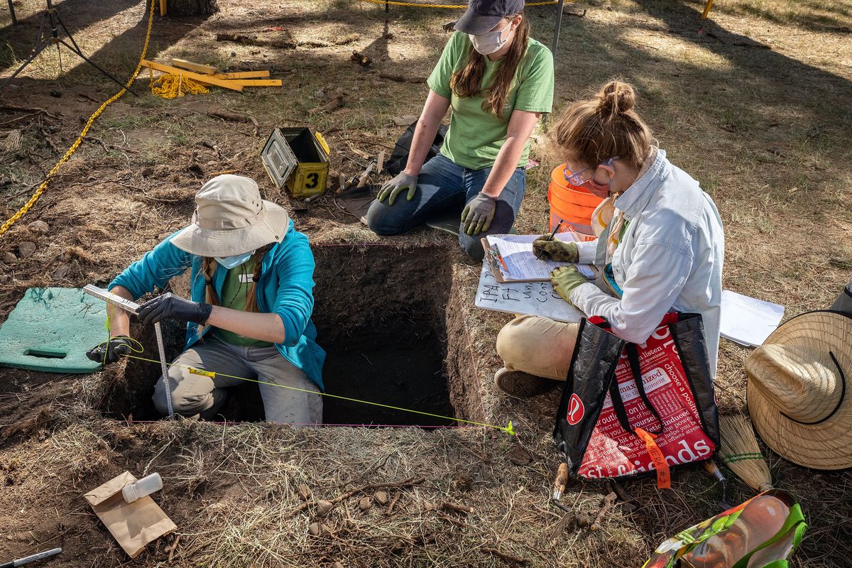 University of Idaho anthropology majors Greta Kuhne, left, and Preslie Murray and University of California, Berkeley, Folklore major Kate Brock document an archaeological dig at North Idaho College Monday.  (COLIN MULVANY/THE SPOKESMAN-REVIEW)