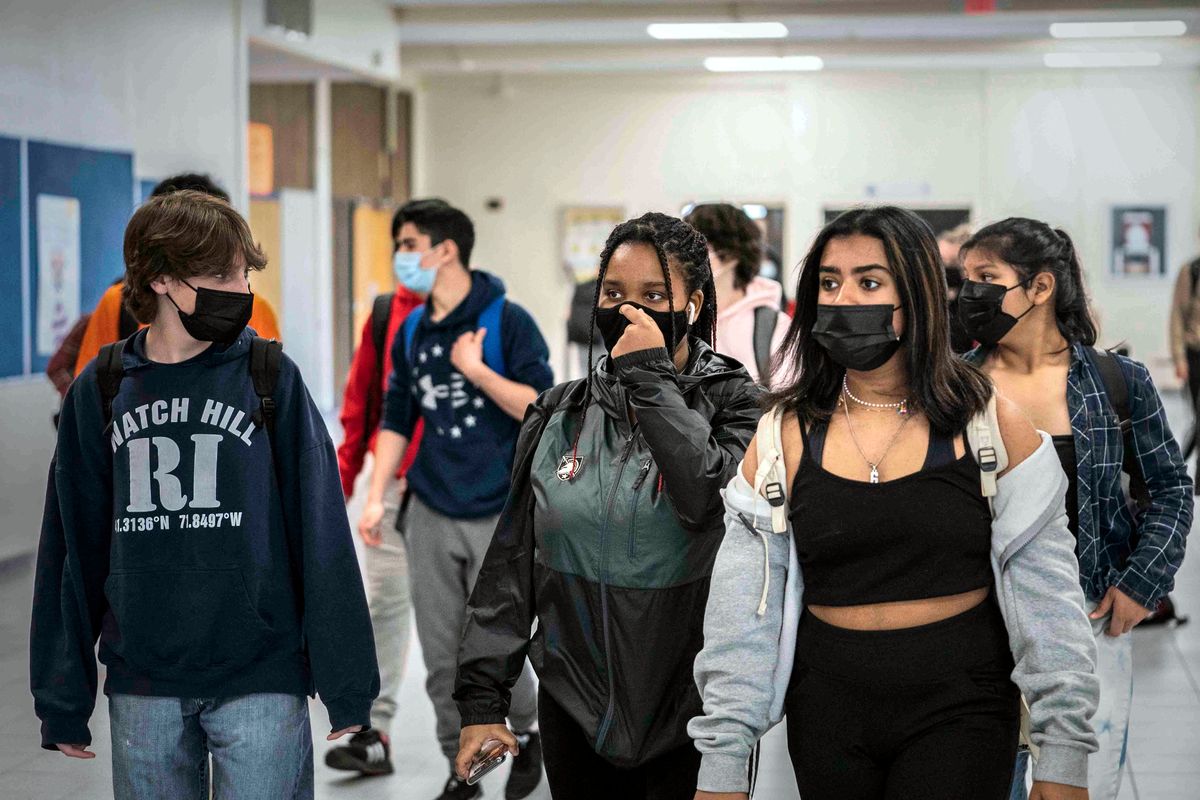 FILE - White Plains High School students walk between classes in White Plains, N.Y., April 22, 2021. The New York State Education Department is telling schools to continue to require masks despite a judge’s ruling overturning the state's mask mandate.  But some school districts already are rushing to drop the requirement.  The Education Department said in a statement Tuesday, Jan. 25, 2022 that the state was appealing the ruling, which could temporarily halt it, and that schools should follow the mask rule in the meantime.  (Mark Lennihan)