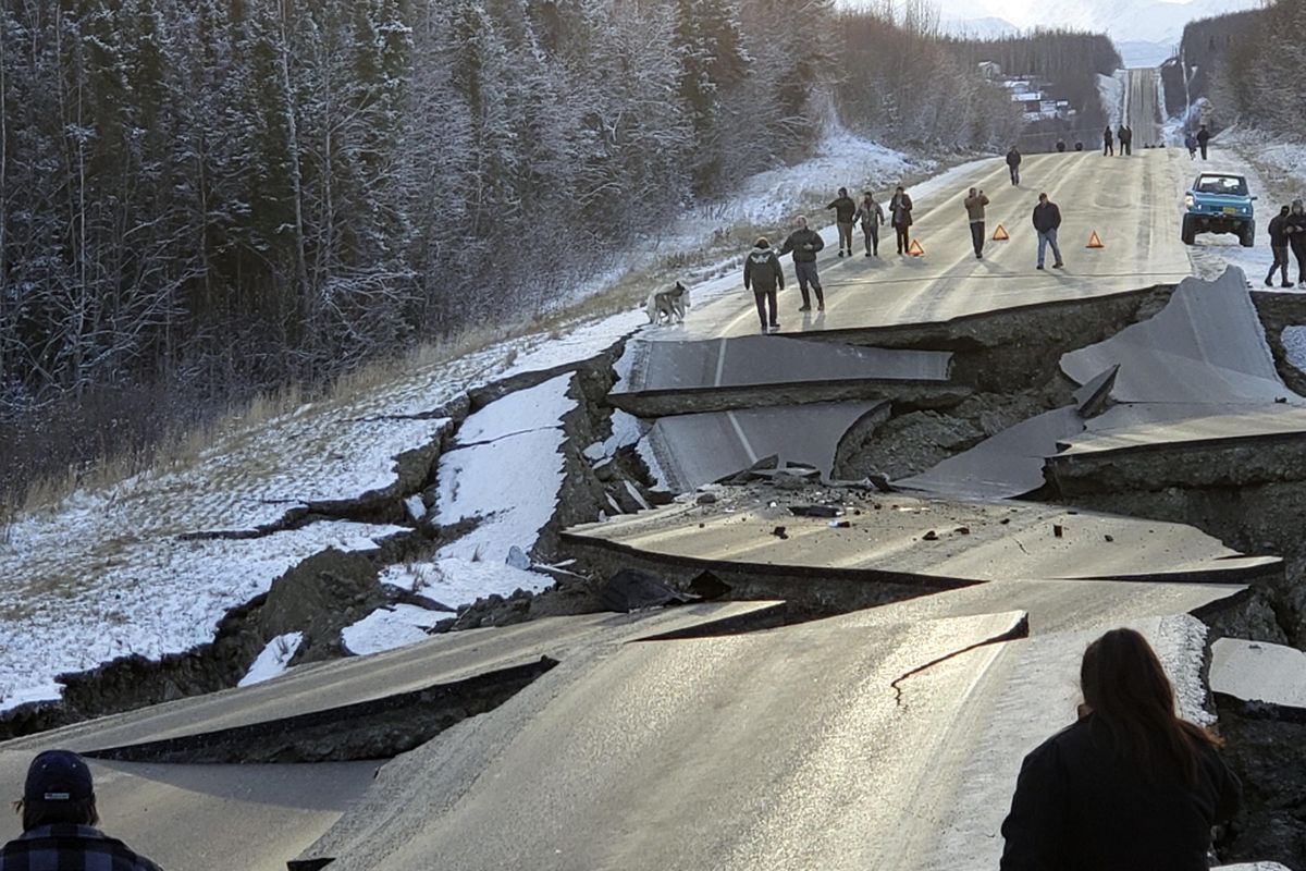 In this Nov. 30 photo, provided by Jonathan M. Lettow, people walk along Vine Road after an earthquake in Wasilla, Alaska. The earthquake registered as a 7.0 on the Richter Scale. (Jonathan M. Lettow / Jonathan M. Lettow)