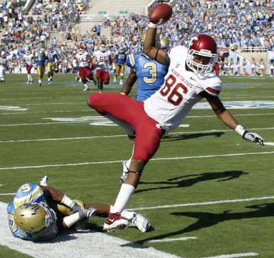 Washington State wide receiver Marquess Wilson, right, gets knocked out of bounds by UCLA safety Tony Dye in the fourth quarter. Replays appeared to show the Wilson crossed the goal line before his right foot came down out-of-bounds. (Chris Carlson / Associated Press)