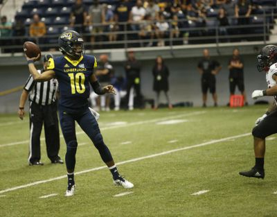 Northern Arizona’s Daniel Bridge Gadd  prepares to throw the ball while being rushed by a Southern Utah University defender during a Sept. 22 game  in Flagstaff, Ariz. (Ben Shanahan / AP)