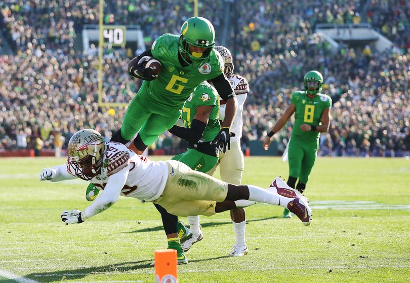Oregon WR Charles Nelson leaps over Florida State's Nate Andrews during the first half of the 101st Rose Bowl Game. (AP)
