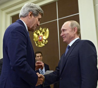 U.S. Secretary of State John Kerry shakes hands with Russian President Vladimir Putin in Sochi, Russia, on Tuesday. (Associated Press)
