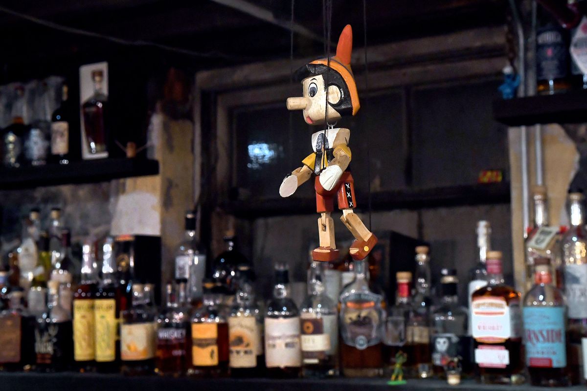 Pinocchio, the official mascot of Hogwash Whiskey Den is suspended above the bar in Spokane on Saturday, June 23, 2018. Several bottles of high end whiskey were lost due to water damage during a recent rain storm. (Kathy Plonka / The Spokesman-Review)