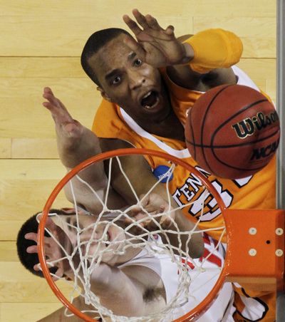 Tennessee’s J.P. Prince, top, and Ohio State’s Kyle Madsen fight for a rebound in the first half. (Associated Press)