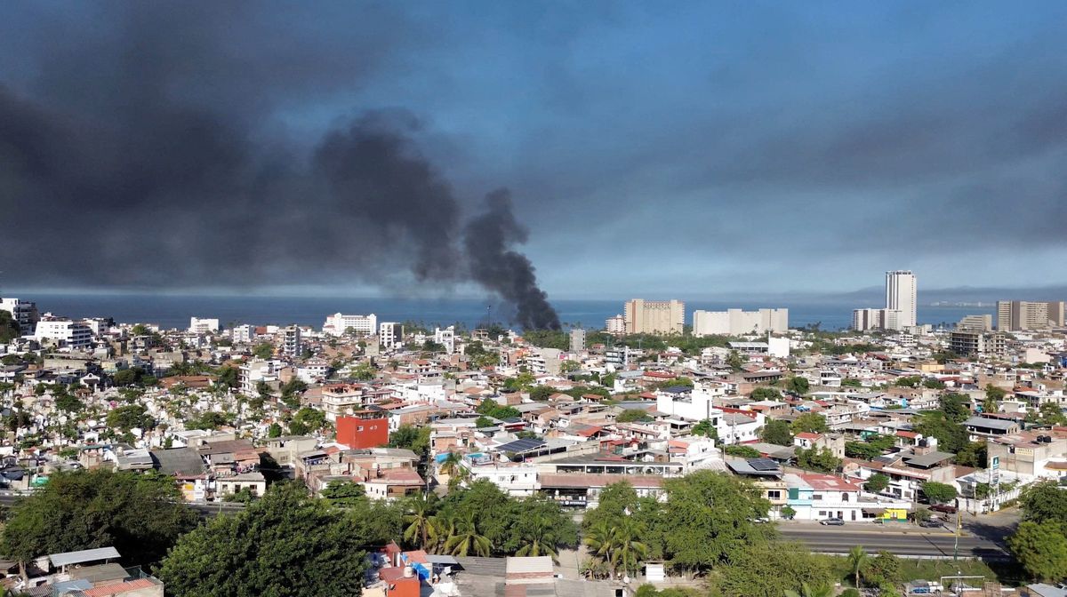 Smoke billows amid a wave of violence, with torched vehicles and gunmen blocking highways in more than half a dozen states, following a military operation in which a government source said Mexican drug lord Nemesio Oseguera, known as "El Mencho," was killed, in Puerto Vallarta, Jalisco, Mexico, February 22, 2026, in this screen grab obtained from a social media video.  (@morelifediares via Instagram)