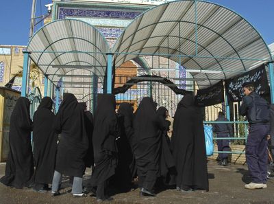 Iranian women wait to enter the holy Shiite shrine of Imam Mousa al-Kazim in Baghdad on Sunday  after a suicide bomber blew herself up among a crowd of pilgrims.  (Associated Press / The Spokesman-Review)