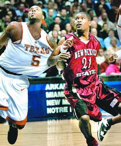 
Former Pullman High School player Fred Peete, right, tangles with Texas guard Damion James during game at Arena. 
 (Brian Plonka / The Spokesman-Review)