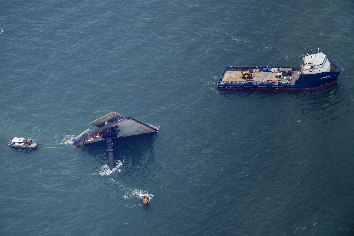 Rescue boats are seen next to the capsized lift boat Seacor Power seven miles off the coast of Louisiana in the Gulf of Mexico Sunday, April 18, 2021. The vessel capsized during a storm on Tuesday.  (Gerald Herbert)