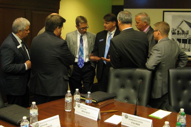 Conference committee members huddle with Deputy Attorney General Brian Kane and Legislative Services Director Eric Milstead before reconvening Friday afternoon (Betsy Russell)