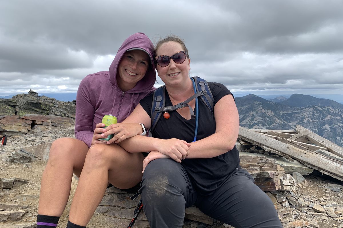 Amanda Nelson and her sister, Nicole Jonak, share a moment on Aug. 8 at the top of Scotchman Peak Trail, a hike near Sandpoint. It was their first training together for a 27.6-mile benefit hike this fall to support cystic fibrosis research and in memory of their sister Krista Baker, who died at age 20 from the disease while awaiting a double lung transplant.  (Courtesy)