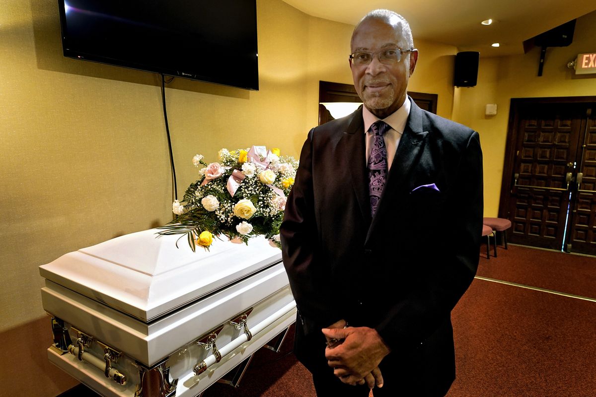 Wayne Bright, funeral director at Wilson Funeral Home poses for a photo in a viewing room before a service Thursday, Sept. 2, 2021, in Tampa, Fla. Bright has seen grief piled upon grief during the latest COVID-19 surge as Florida is in the grip of its deadliest wave since the pandemic began, a disaster driven by the highly contagious delta variant. (Chris O
