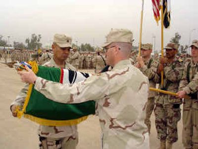 
Brig. Gen. Oscar Hilman, left, and Command Sgt. Major Robert Barr, case the flag of the 81st Brigade Combat Team during the Transfer of Authority ceremony Thursday. 
 (Photo courtesy of Capt. Kyle Yonemura/U.S. Army / The Spokesman-Review)