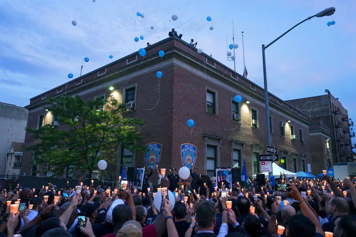 Police officers and community members release balloons during a vigil in front of New York police department’s 46th Precinct during a tribute to police officer Miosotis Familia in the Bronx borough of New York, Saturday, July 8, 2017. Familia was shot to death early Wednesday, ambushed inside her command post by an ex-convict, who was later killed after pulling a gun on police in New York . (Craig Ruttle / Associated Press)