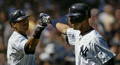 
Derek Jeter, right, celebrates after his third-inning home run. 
 (Associated Press / The Spokesman-Review)