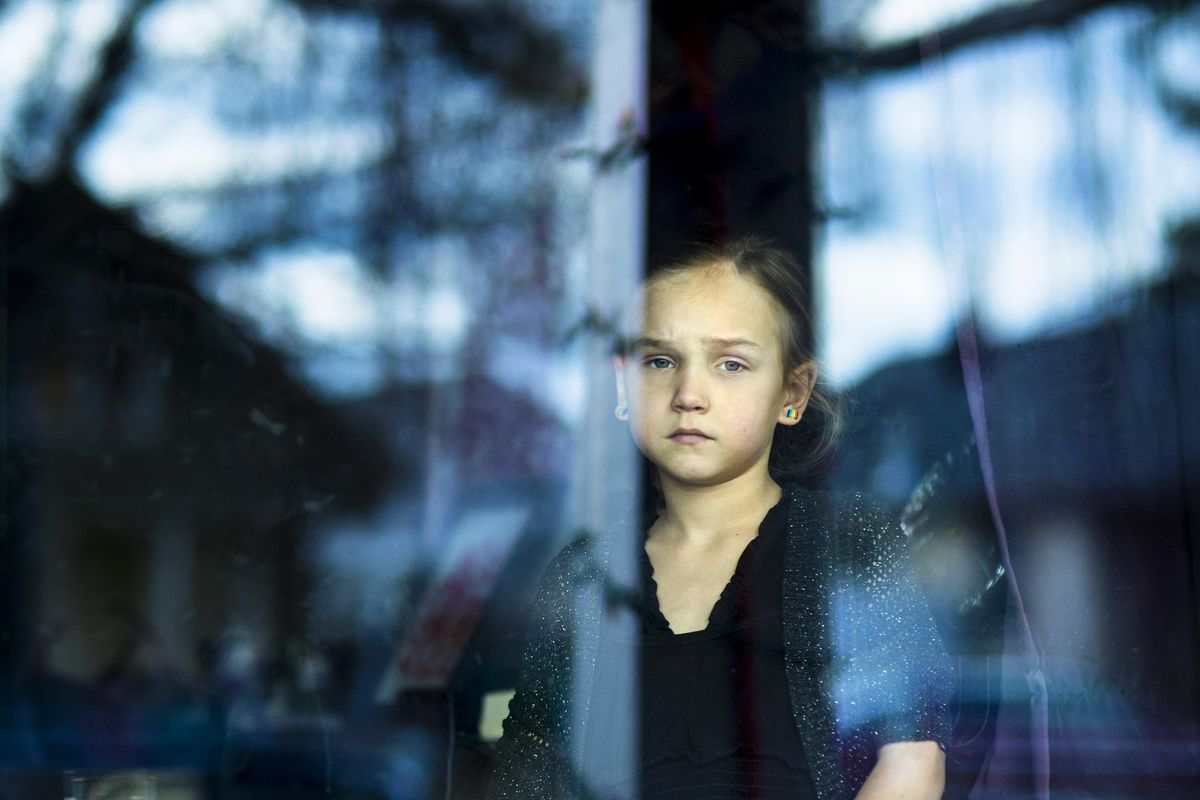 Spokesman-Review photojournalist Colin Mulvany won First Place Metro Portrait with this photo in the 2016 Associated Press Northwest Photo Contest. Rachel White, 8, stares out her living room window as she waits for her parents to come home from work. White, a transgender girl, came out when she was in preschool. Her parents have supported her transition. Betsy White, her mother, says “I had a decision to make. I could support my child or I could bury my child.” (Colin Mulvany / The Spokesman-Review)