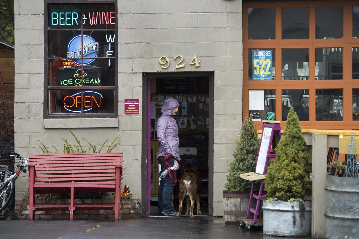 Katie Bell, 29, and her dog Rugby, 7, visit The Shop in the South Perry District on April 17, 2014, in Spokane. They live in the neighborhood. (Dan Pelle / The Spokesman-Review)