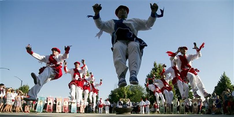 Onati Basque dancers go airborne as they perform Basque traditional dances while making their way to the front of Saint Mark's Catholic Church, Saturday, Aug. 1, 2015, in Boise, for an annual mass conducted in Basque and English that’s part of the Jaialdi festival. (AP/Idaho Statesman / Kyle Green)