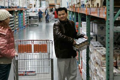 
Andy Ta, of White Center, Wash., picks up a package of Starbucks Frappuccino drinks to purchase at a Costco Wholesale warehouse in Seattle last week. Starbucks products account for about 90 percent of the ready-to-drink coffee market in the United States. 
 (Associated Press / The Spokesman-Review)