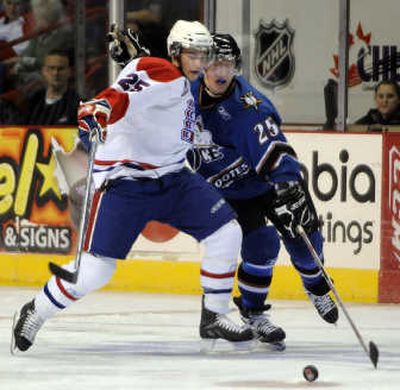 Levko Koper, left, battles Kootenay's Ian Barteaux for control of the puck.
 (Dan Pelle / The Spokesman-Review)