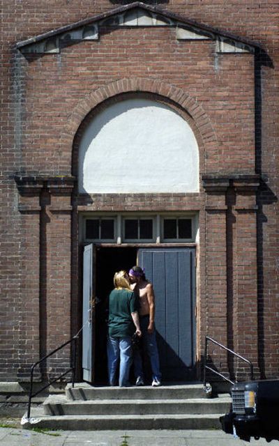 
Dave Gmur kisses girlfriend Barbara Martin at the old Hillyard High School. 
 (Holly Pickett / The Spokesman-Review)