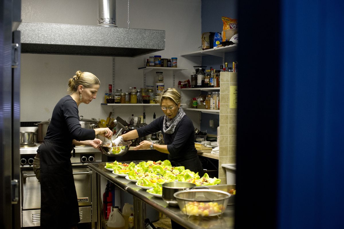 Julia Postlewait, left, and Karen Johnson prepare salads recently at Blue Table Kitchen in Millwood. (Tyler Tjomsland)
