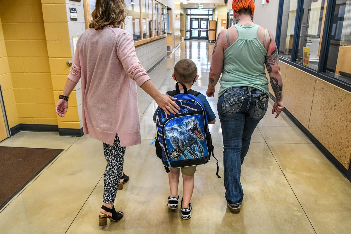 Lincoln Heights Elementary School Principal Meghan Anderson, left, walks Logan Fisher and his mother, Brianna, to class on the first day of kindergarten, Wednesday, Sept. 8, 2021 in Spokane.  (Dan Pelle/THE SPOKESMAN-REVIEW)