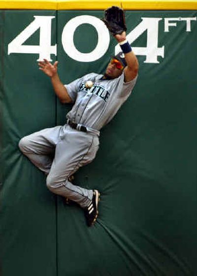 
Seattle Mariners center fielder Hiram Bocachica robs Texas Rangers' Hank Blalock of a hit with a catch in the second inning during Texas' 9-7, 18-inning comeback win, at Ameriquest Field in Arlington, Texas Thursday, June 24, 2004. Bocachica caught the ball with his bare hand after hitting the wall. (AP Photo//The Dallas Morning News, Louis DeLuca) ORG XMIT: TXDAM104Hiram Bocachica, who ended up catching this ball with his bare hand in the Associated Press photo of the month for June, could see more playing time in the second half.
 (Louis DeLuca/Dallas Morning News / The Spokesman-Review)