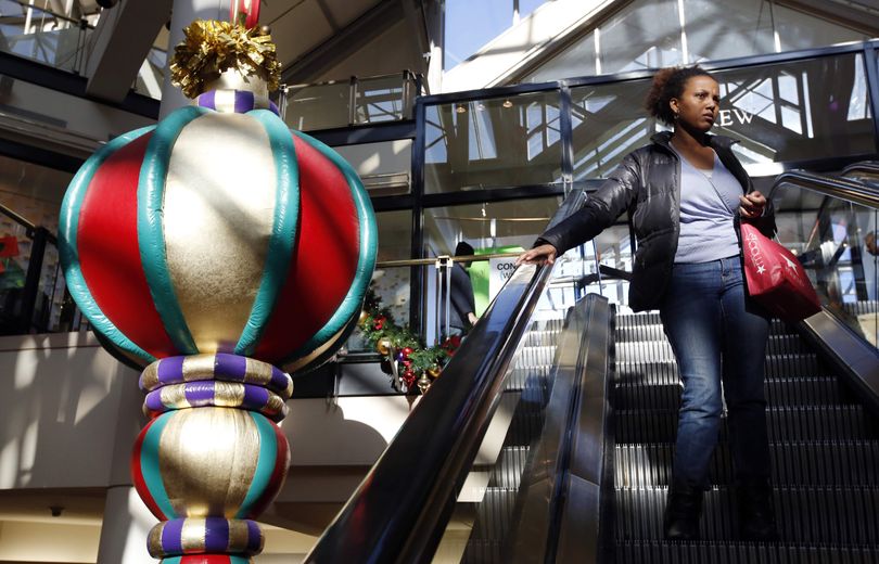 A woman rides the escalator past a giant holiday ornament at the CambridgeSide Galleria mall in Cambridge, Mass., Monday, Dec. 24, 2012. Although fresh data on the holiday shopping season is expected in coming days, early figures point to a ho-hum season for retailers despite last-ditch efforts to lure shoppers over the final weekend before Christmas. And with concerns about the economy and the looming �fiscal cliff� weighing on the minds of already cautious shoppers, analyst say stores will need to offer �once in a lifetime� blowouts to clear out inventory. (Michael Dwyer / Associated Press)