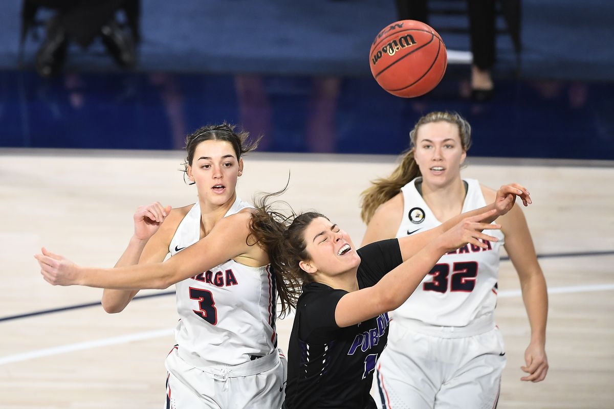 Gonzaga Bulldogs forward Jenn Wirth (3) and guard Jill Townsend (32) vie for a rebound against Portland Pilots forward Alex Fowler (12) during the first half of a college basketball game on Saturday, January 9, 2021, at McCarthey Athletic Center in Spokane, Wash.  (Tyler Tjomsland/THE SPOKESMAN-RE)