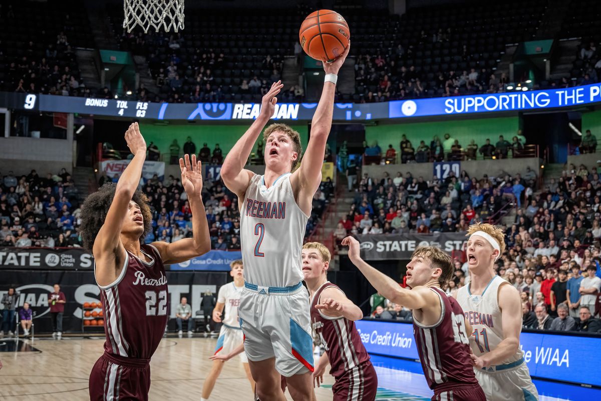 Freeman guard Colton Wells shoots as Reardan forward Jakari Singleton (22) defends during Friday’s State 2B tournament semifinal at the Arena. (COLIN MULVANY)