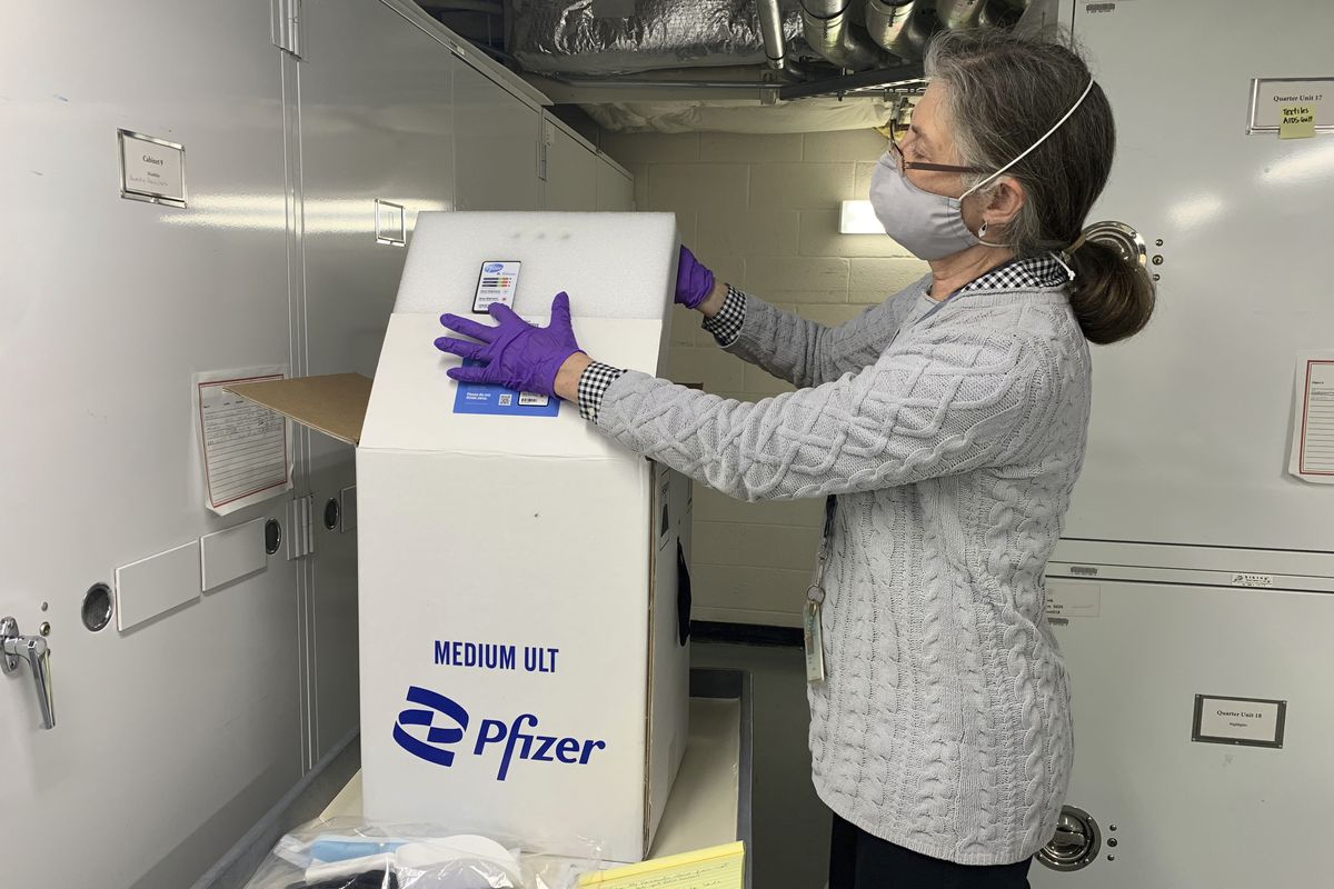 Curator Diane Wendt shows that specialized container used to ship super cold doses of the Pfizer COVID-19 vaccine in Washington, on Monday, March 8, 2021. The package and other items related to the first dose of vaccine administered in the U.S. have been donated to the Smithsonian