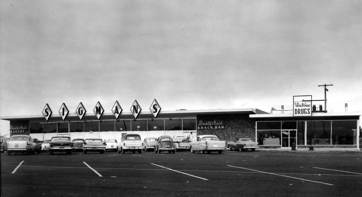 1960: Sigman’s Westview supermarket and Westview Drugs in northwest Spokane opened in 1960. The store is located two blocks south of Francis Avenue on G Street. The building was designed by architect Warren C. Heylman and constructed by Western Builders company of Spokane. The store represents the continued development of smaller, independent grocery stores, even as Safeway, Albertson’s and other chains were growing regionally and building larger stores. By around 1970, the store became an IGA Foodliner store.  (Spokesman-Review Photo Archives)
